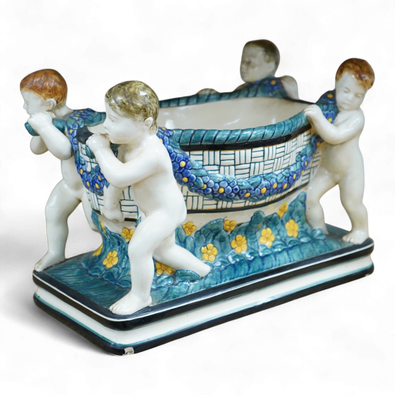 A Karlsruhe jardiniere with four putti designed by Wilhelm Süs in 1908, model number 1002, 33cm wide